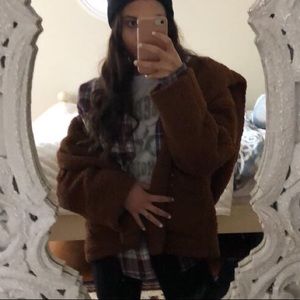 Brown fuzzy coat. No zipper. Very comfy and warm.